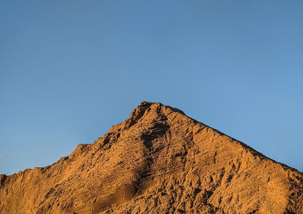 brown rocky mountain under blue sky during daytime