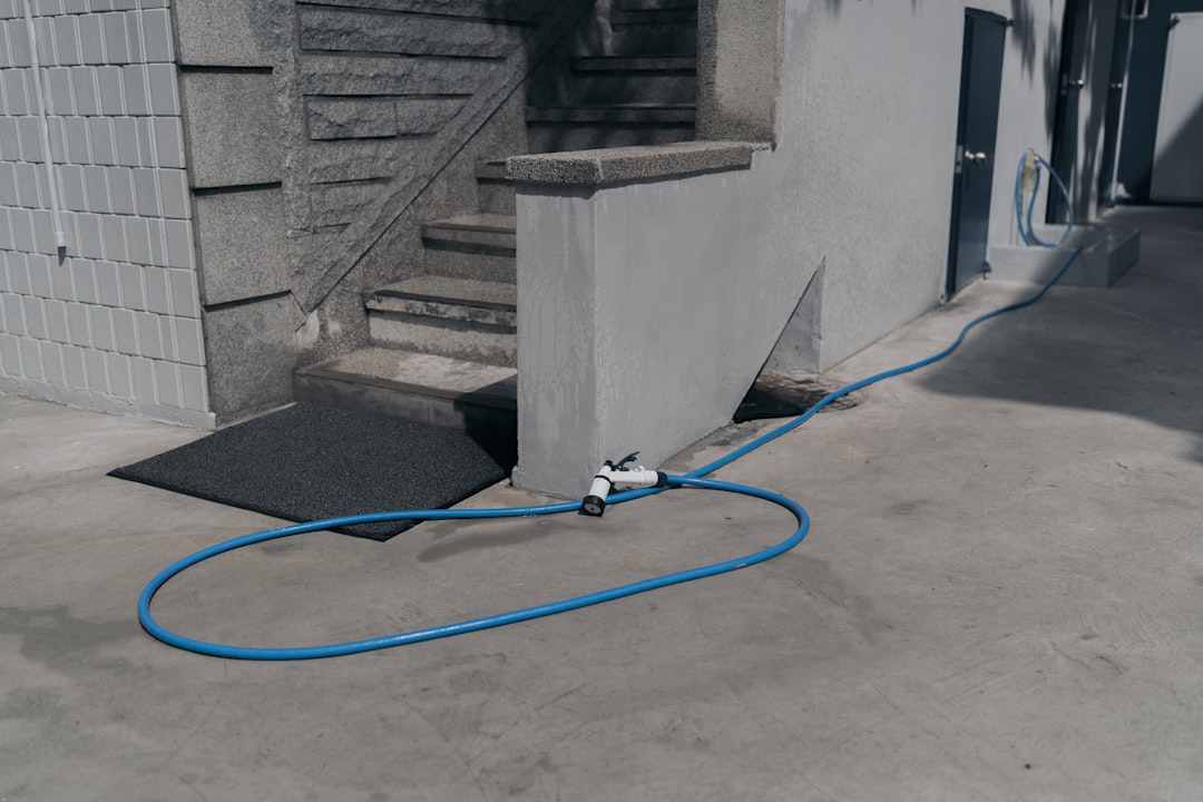 blue hose on gray concrete stairs