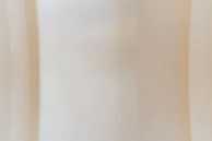 Soft pastel textured surface brightening a residential bedroom.