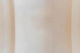 Soft beige abstract shapes layered with subtle textures reflecting warmth and connection.