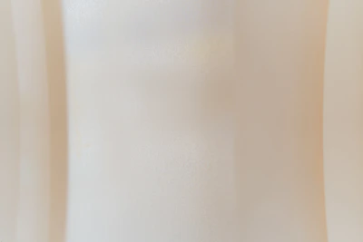 Abstract composition blending sandy beige and white warm hues with subtle textures.