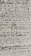 A close-up view of textured concrete with visible lines and small pebbles embedded in the surface.