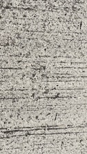 A close-up view of textured concrete with visible lines and small pebbles embedded in the surface.