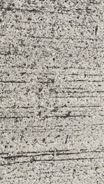 A close-up view of textured concrete with visible lines and small pebbles embedded in the surface.