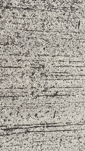 Close-up of freshly poured brushed concrete slab with visible texture in an industrial yard.