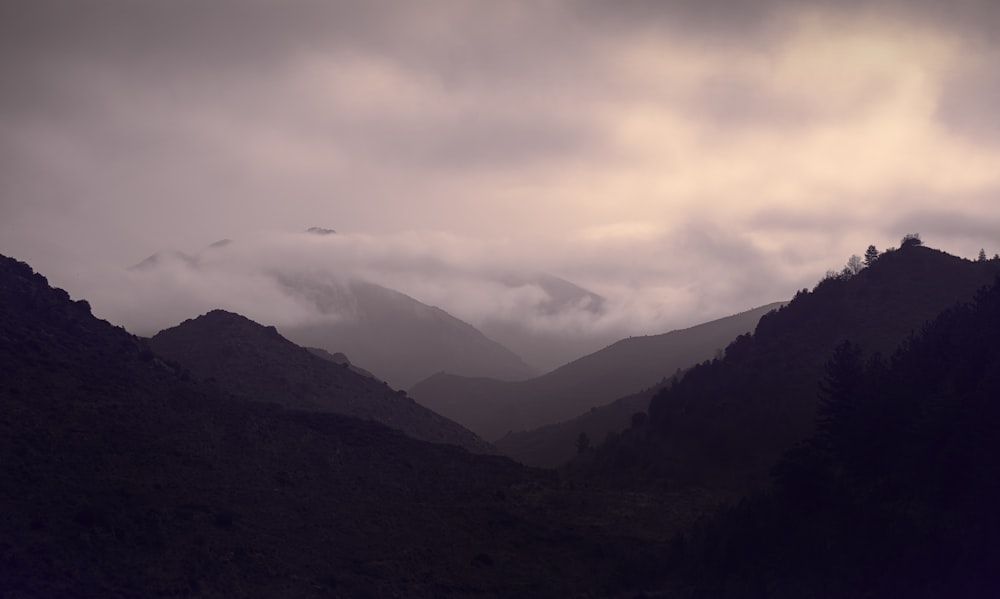 mountains under white clouds during daytime