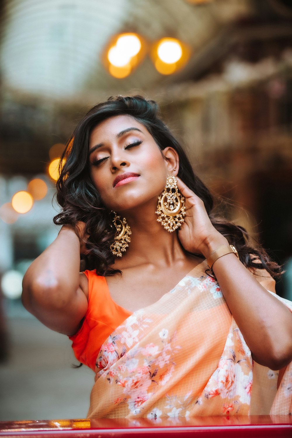 woman in orange and white floral dress wearing gold crown