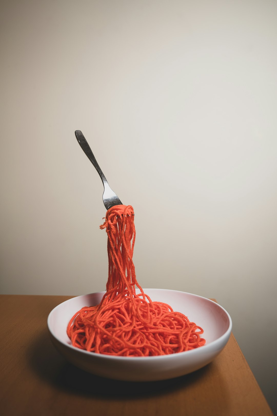 red pasta on white ceramic bowl