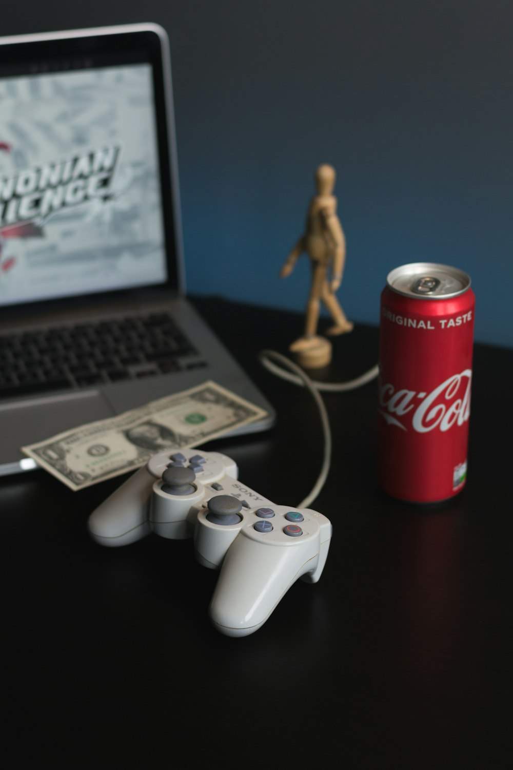 white sony ps 4 controller beside coca cola can