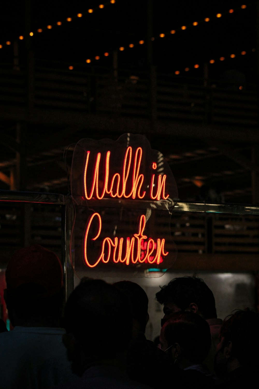 a neon sign that reads walk in counter