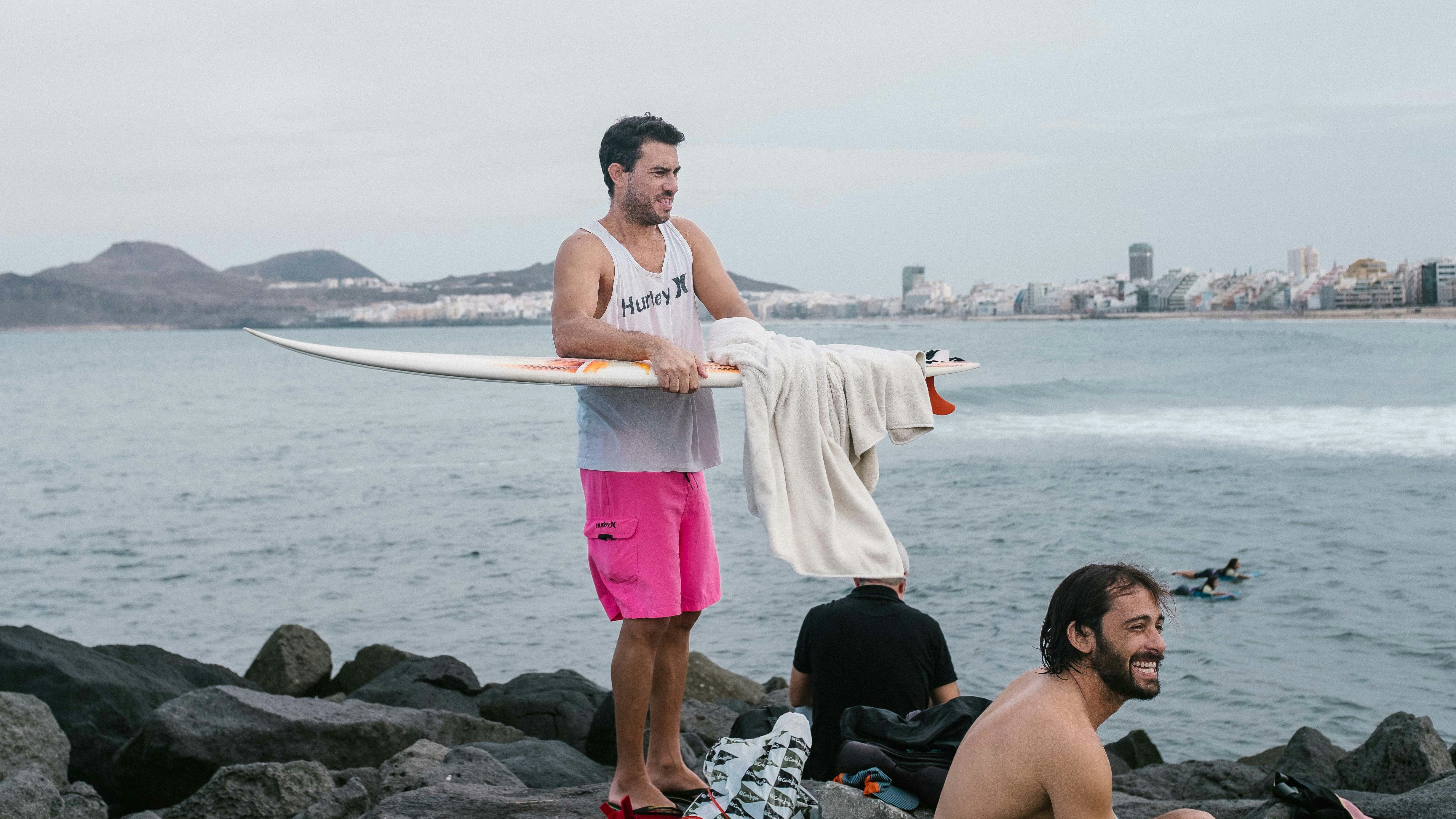 man in white and red tank top standing on rock near body of water during daytime, Street shots from my Trip to Gran Canaria 2019. Enjoy