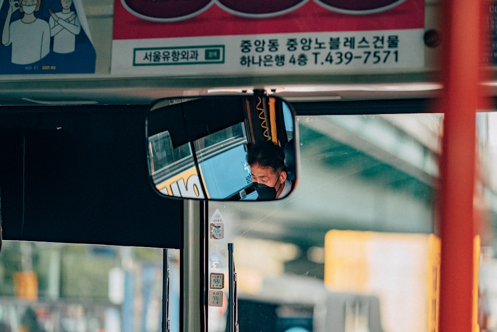 black car side mirror showing black car