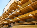 Wooden planks arranged in an organized warehouse setting.