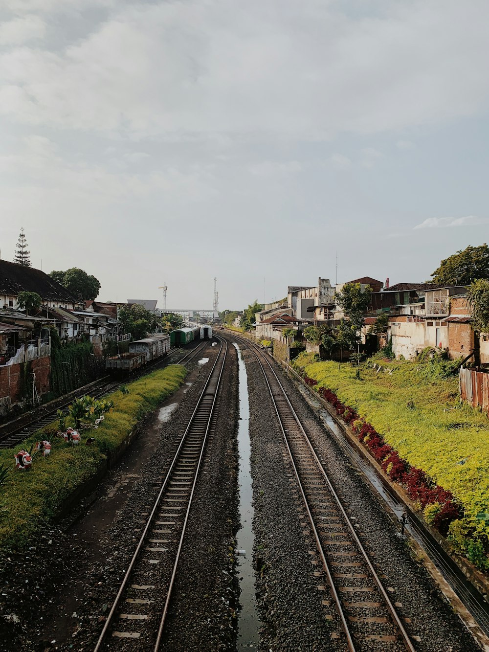 train rail near houses during daytime