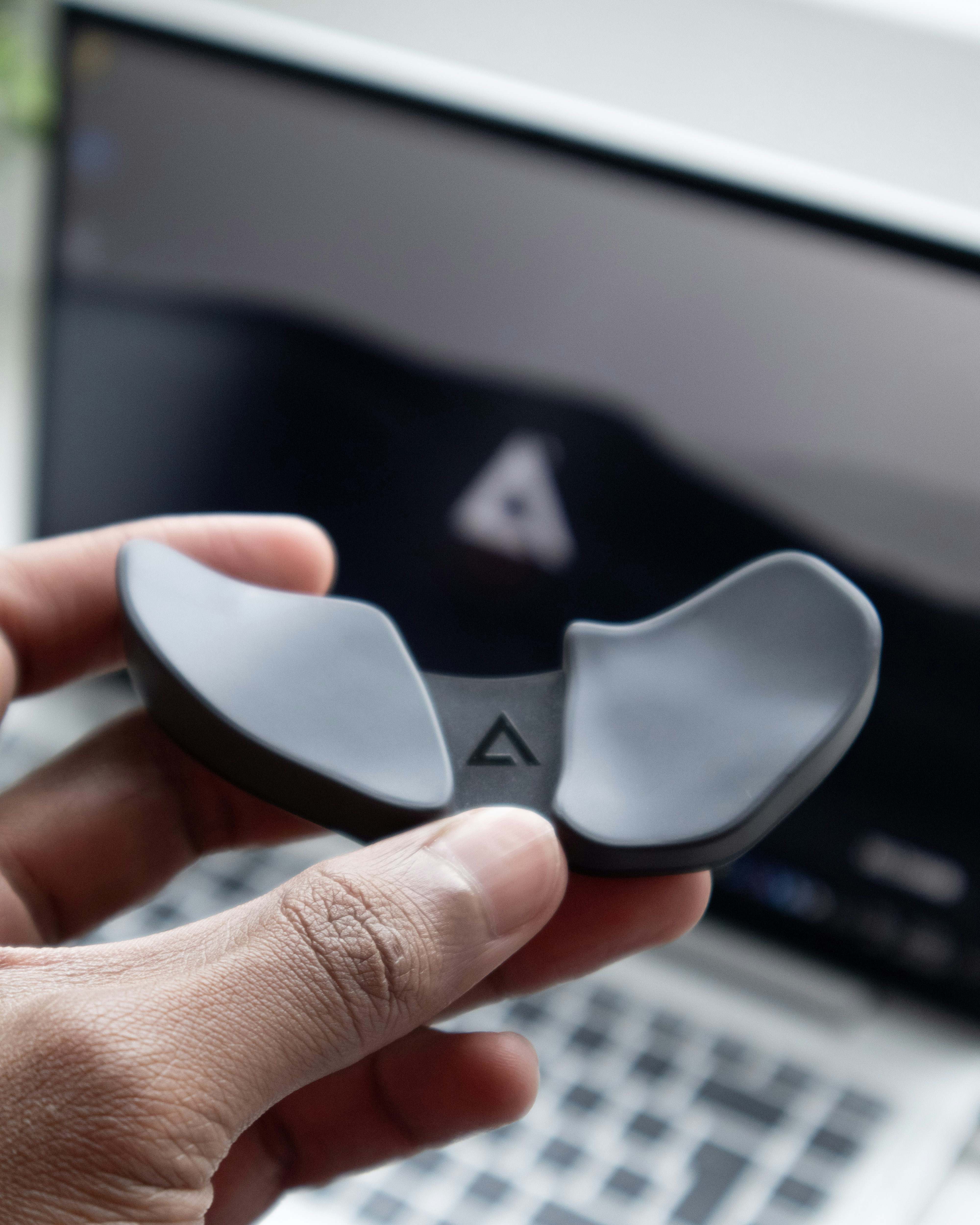 person holding white and black plastic tool