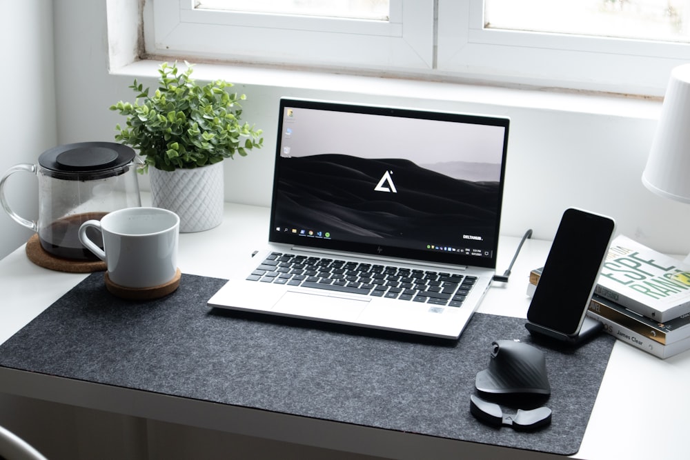 macbook pro on black table