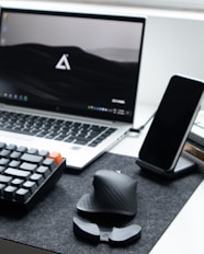 black and white computer keyboard beside black ipad