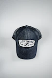 A sleek white baseball cap with ‘Piercecc’ written in minimalist font across the front