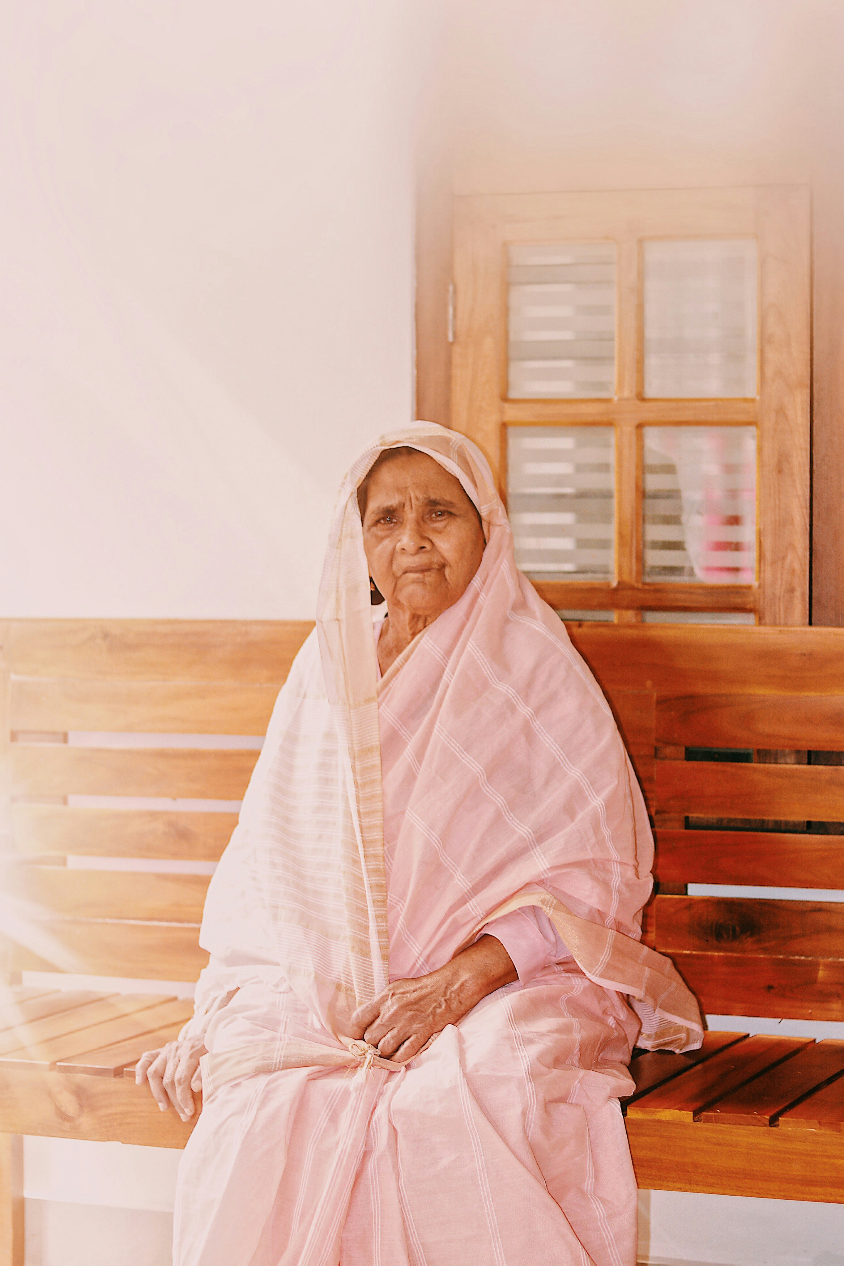Woman in white hijab sitting on brown wooden bench photo – Free Woman ...
