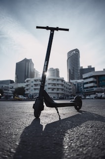 A vibrant electric scooter parked in an urban setting.