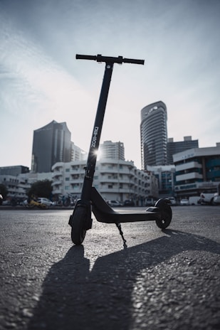 A vibrant electric scooter parked in an urban setting.