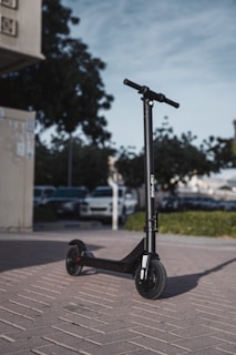 black kick scooter on gray concrete road during daytime