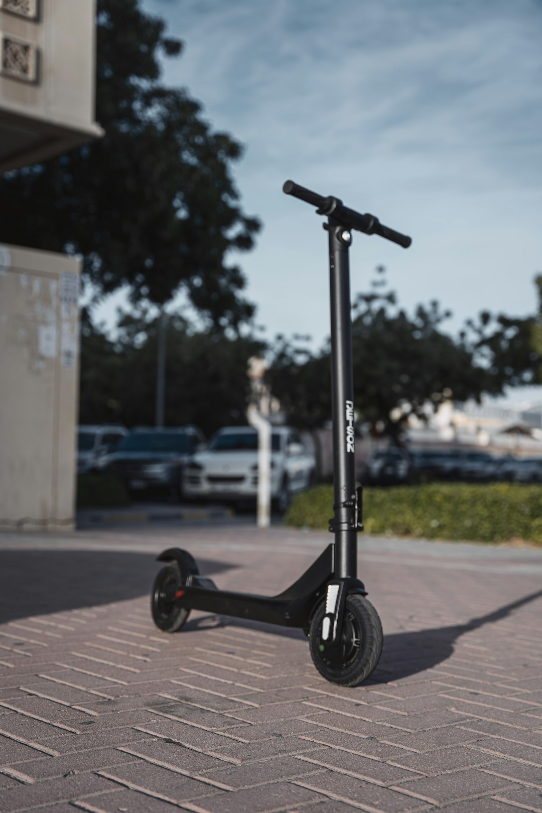 black kick scooter on gray concrete road during daytime