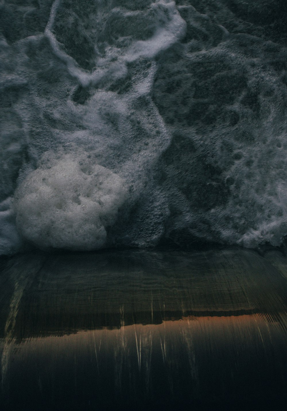 water waves on brown wooden surface