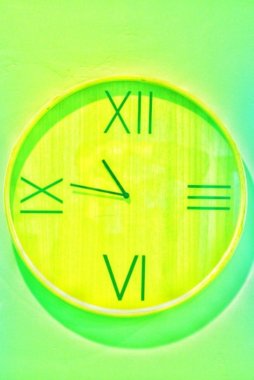 A vibrant promotional wall clock featuring bold colors and clear numbers on an office wall.