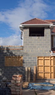 brown brick house under blue sky during daytime