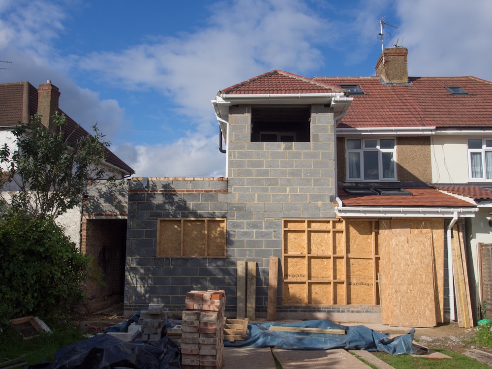 brown brick house under blue sky during daytime