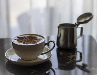 A steaming cup of creamy traditional soy milk with a light froth on top.