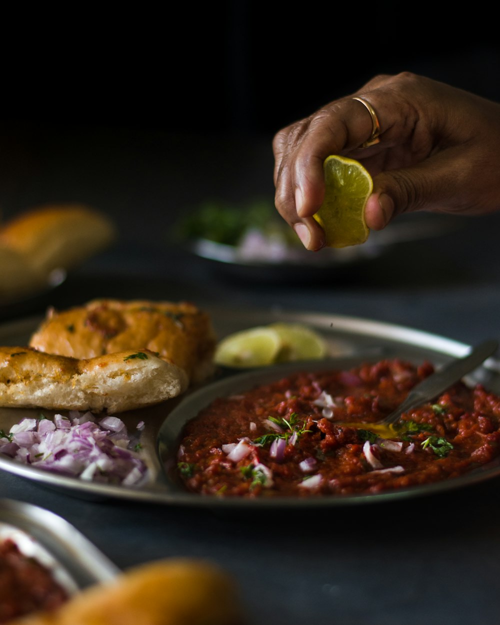 a plate of food that includes bread, salsa, and bread rolls