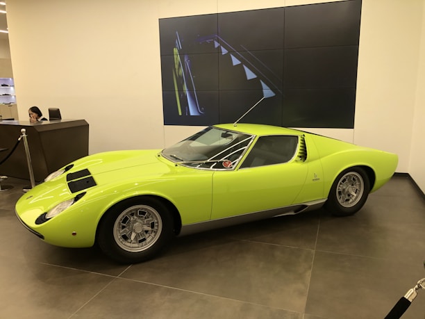 Friendly staff assisting a customer with vehicle documents in a bright office.