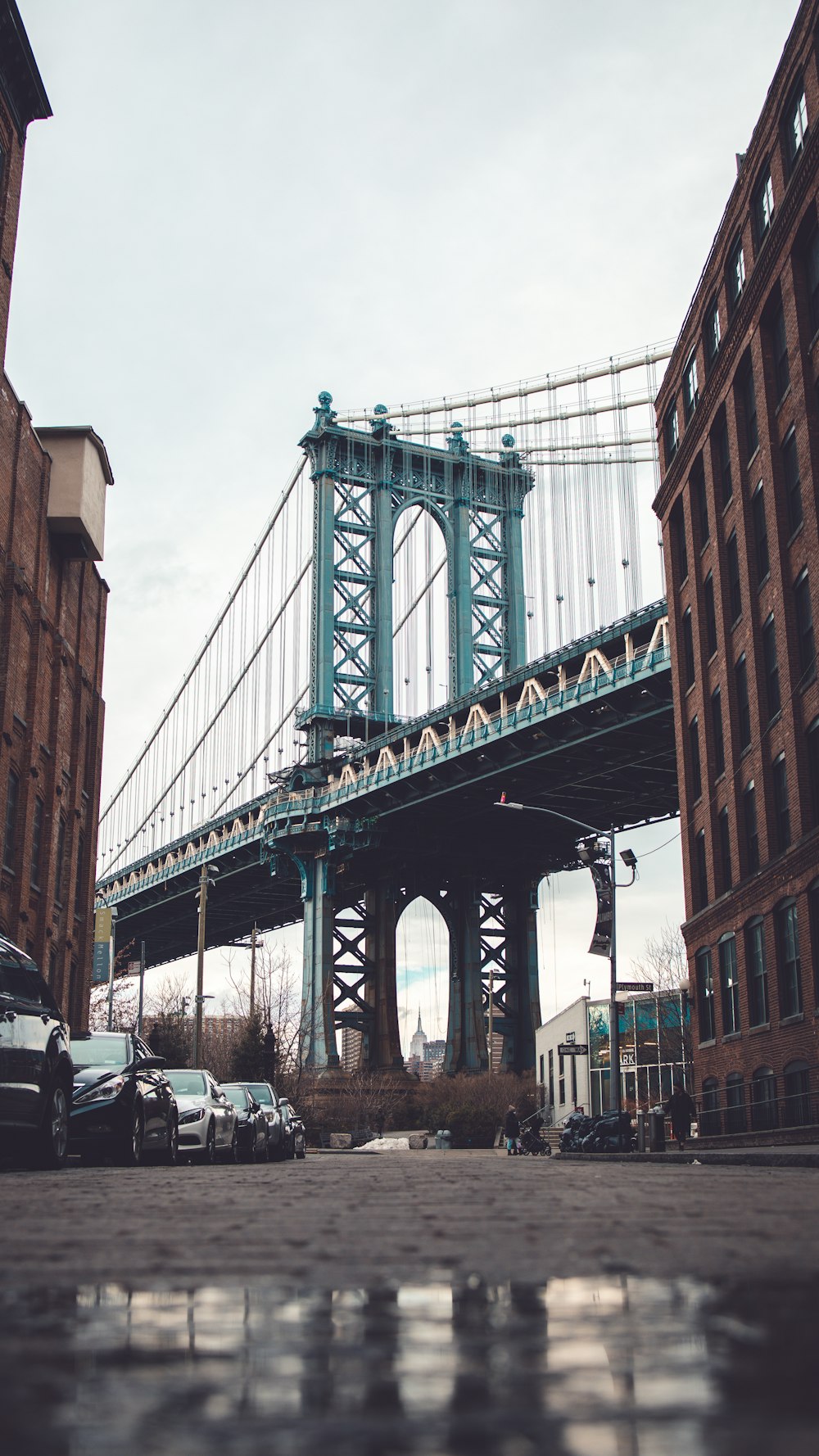 cars parked on side of the bridge during daytime