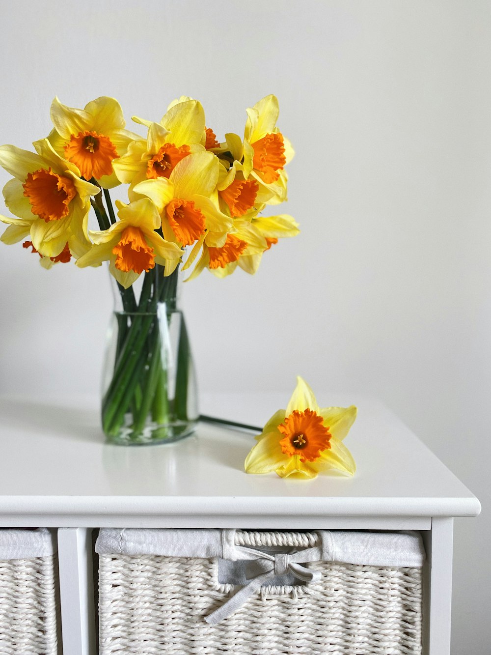 yellow daffodils in clear glass vase