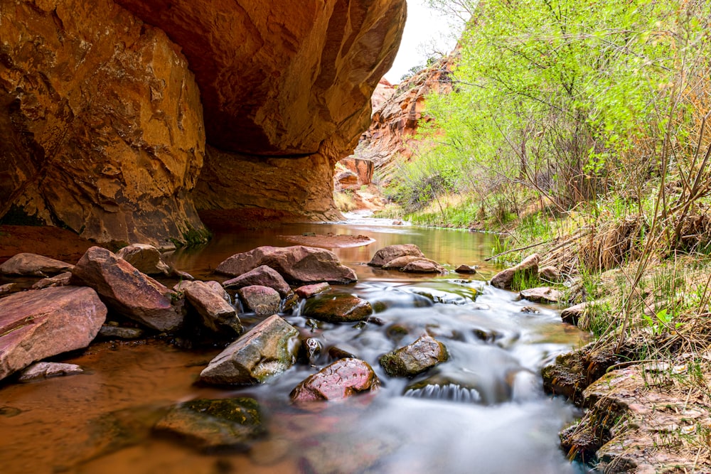 brown rock formation near river during daytime