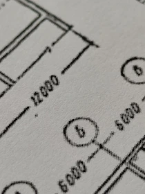 Close-up of a technical drawing being digitized on a computer screen.