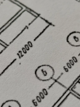 Close-up of detailed architectural blueprints with precise measurements and annotations.