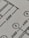 Close-up view of a technical drawing or blueprint featuring measurements and diagrams. The image shows lines, numbers, and symbols commonly used in architectural or engineering designs.