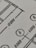 Close-up view of a technical drawing or blueprint featuring measurements and diagrams. The image shows lines, numbers, and symbols commonly used in architectural or engineering designs.