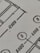 Close-up view of a technical drawing or blueprint featuring measurements and diagrams. The image shows lines, numbers, and symbols commonly used in architectural or engineering designs.