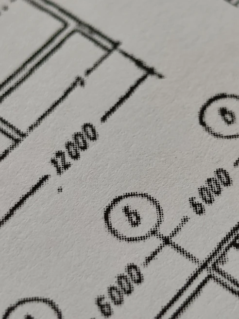 Close-up of skilled engineer reviewing blueprints on a construction site