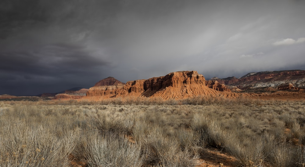 brown rocky mountain under cloudy sky during daytime