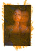 A portrait of a person with an overlay effect, making the person's face appear duplicated and creating a blurry, dreamlike appearance. The background and the edges of the image have an abstract, textured effect in orange, contrasting with the darker tones within the portrait.