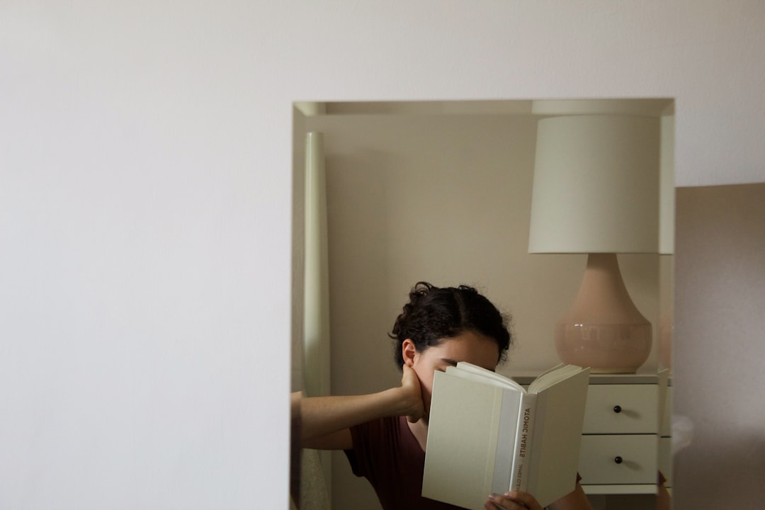 woman in black shirt holding white printer paper