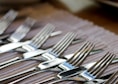 stainless steel fork lot on brown wooden table