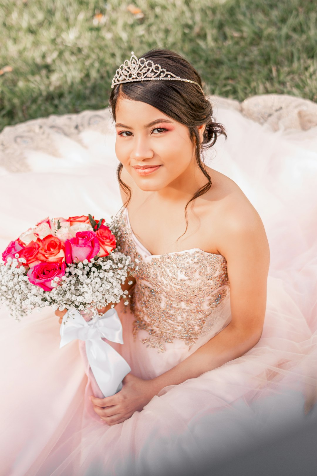 woman in white floral wedding dress holding bouquet of flowers