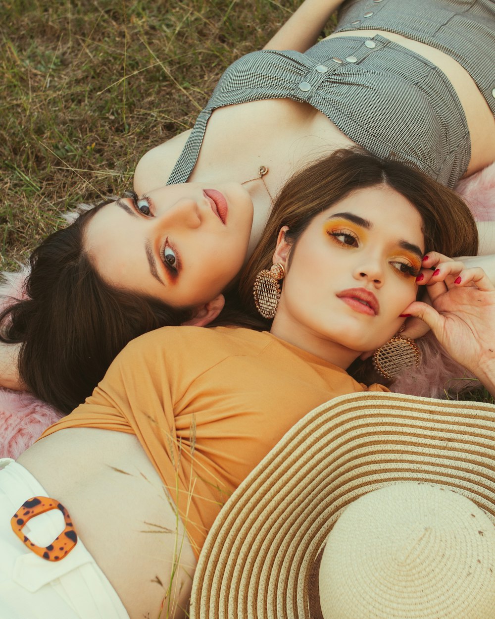 woman in orange shirt lying on grass