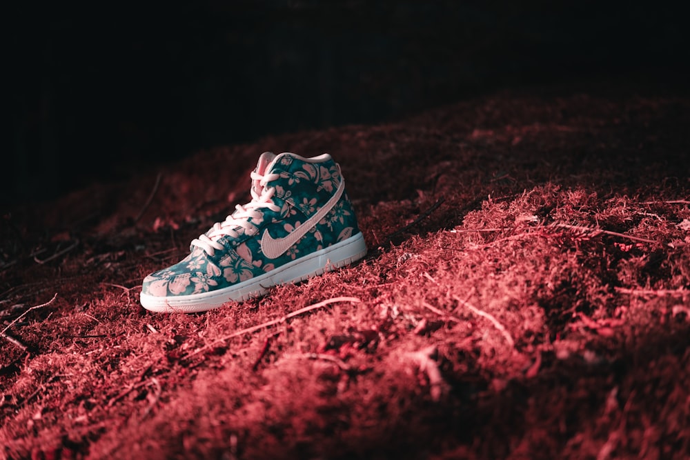 black and white nike high top sneakers on red textile